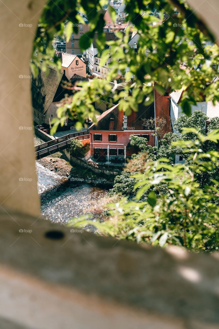 Looking down on a little bridge and a pink building 