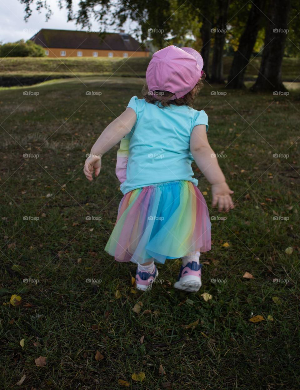 tiny little girl dance with her self in the park . She is sooo cute, dont ya think