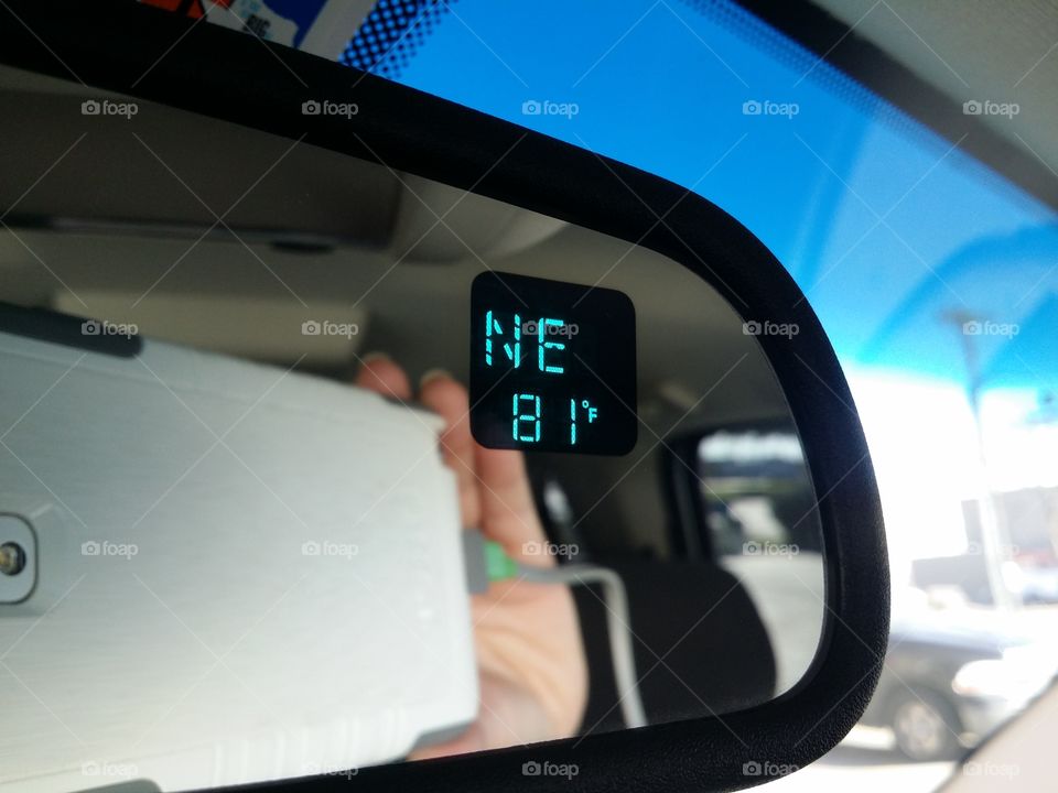 The temperature compass mirror in my car and my smartphone camara taking a photo of it