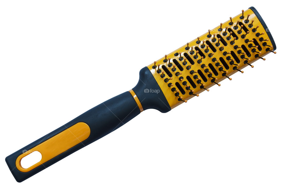 Yellow hairbrush on a white background