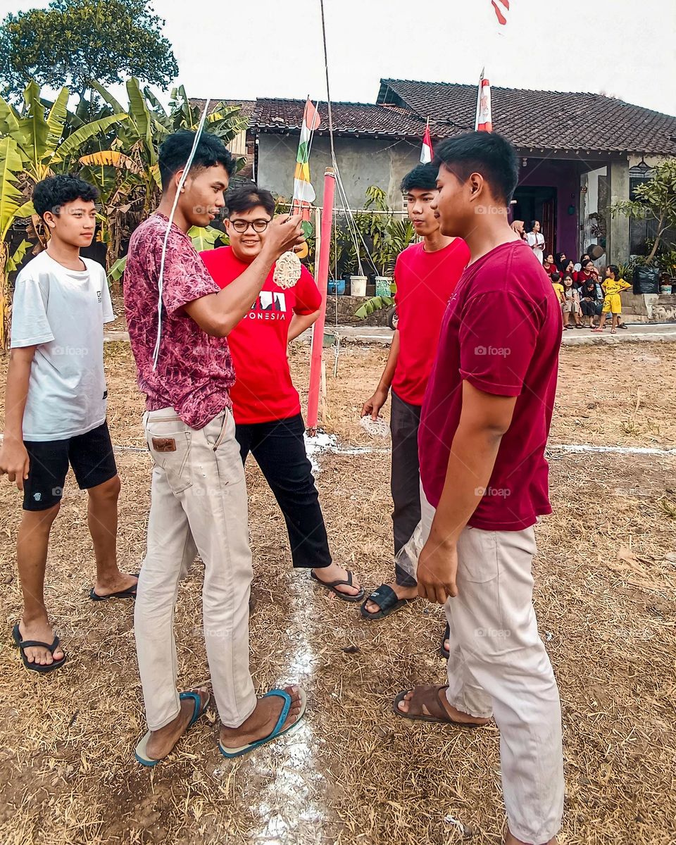 Portrait of a group of teenage boys together preparing a cracker eating competition to celebrate Indonesia's independence day