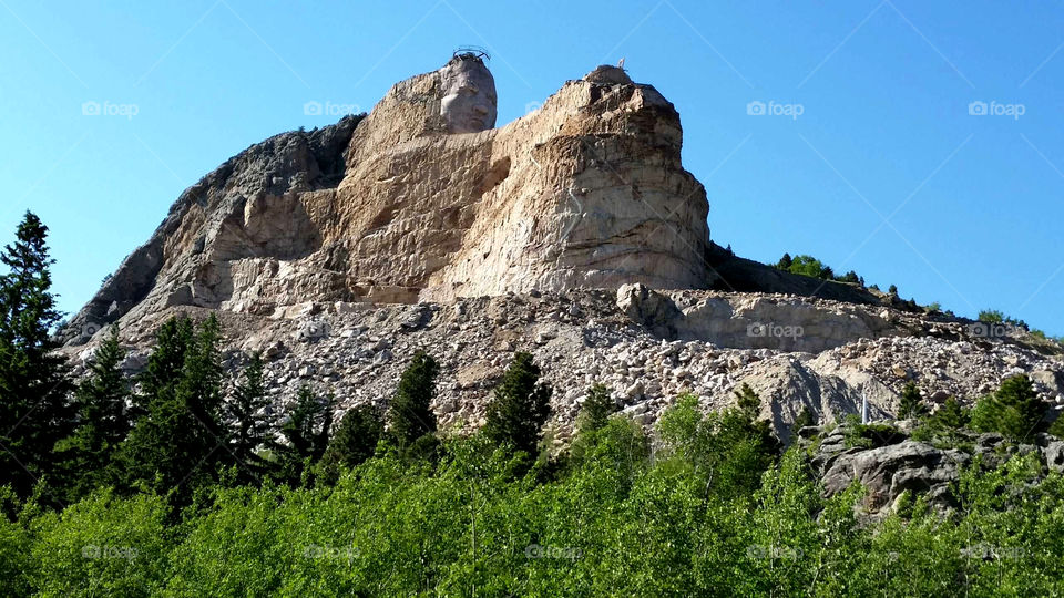 Crazy Horse monument on a beautiful blue sky day in South Dakota.