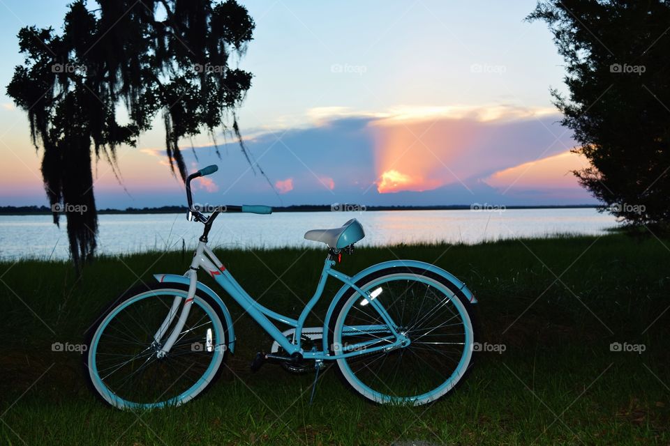 Bike by a river at sunset