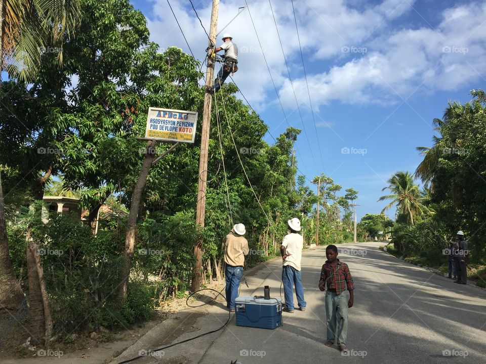 Li mane climbing pole in Haiti for rural electrification project
