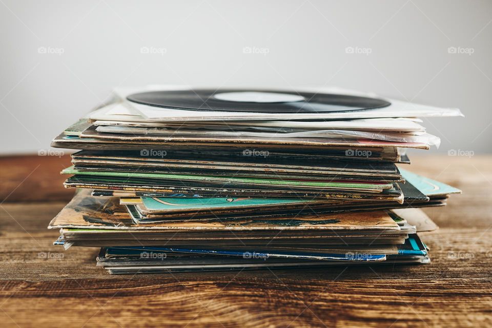 Stack of vinyl records. Listening to music from record. Playing music from analog disk. Retro and vintage. Audio stereo. Analog sound