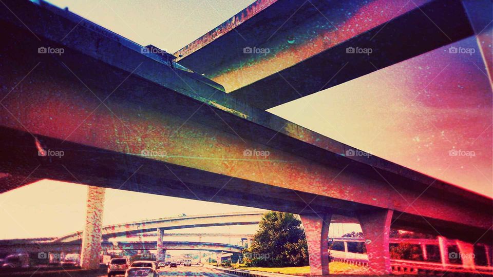 two overpass Bridges criss cross over one another above a highway