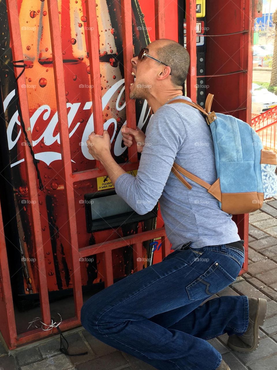 Man in front of soft drink machine