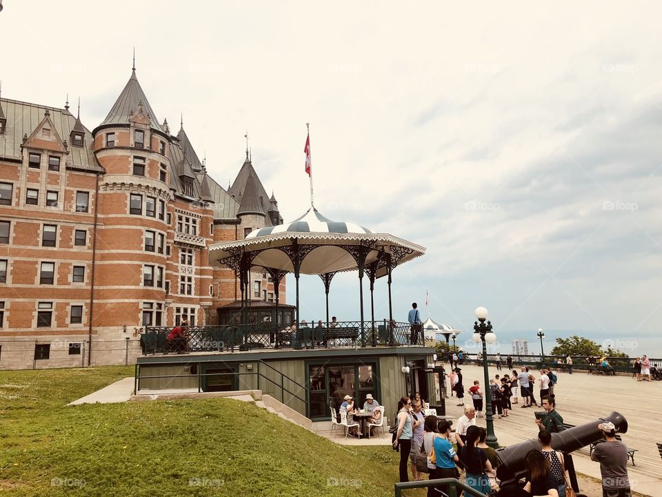 Chateau Frontenac hotel and a gazebo on the St Laurent river pier on a cloudy day in Quebec city