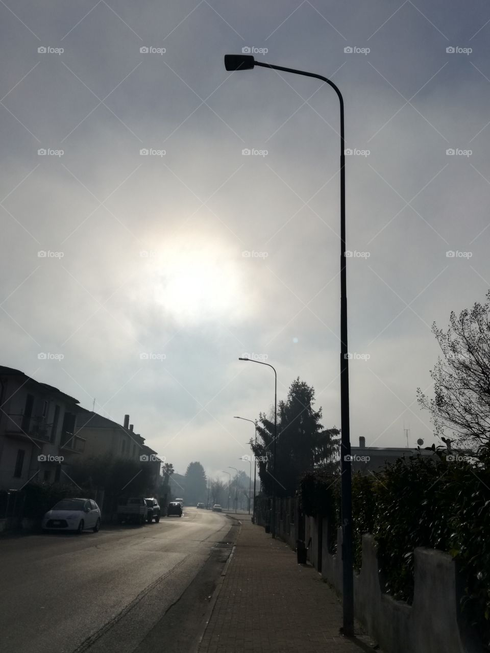 Some fog and the sun under the clouds