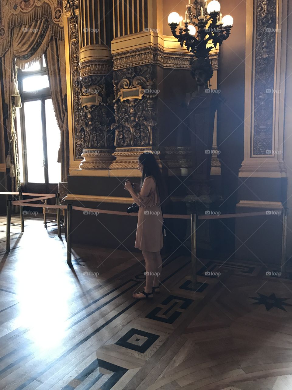 Woman standing in museum using mobile phone