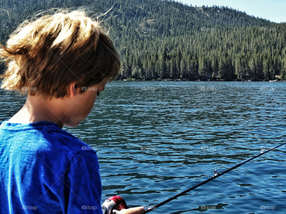 Young boy fishing on a lake