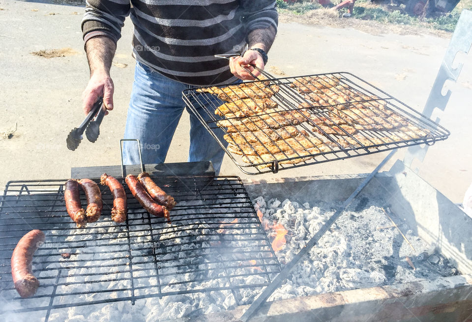 Man Roasting Barbecue On Grill Greek Souvlakia Pork Meat
