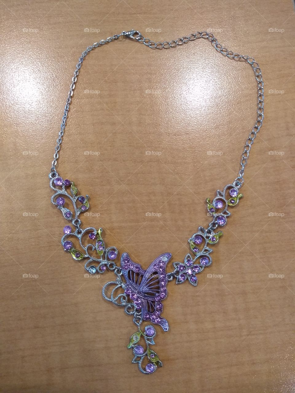 gorgeous butterfly necklace with light purple and neon green gemstones