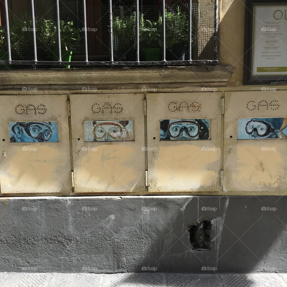 Graffiti in Florence showing parts of famous portraits as SCUBA divers