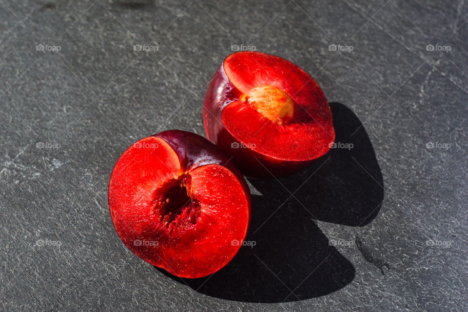 red plum on a dark stone background