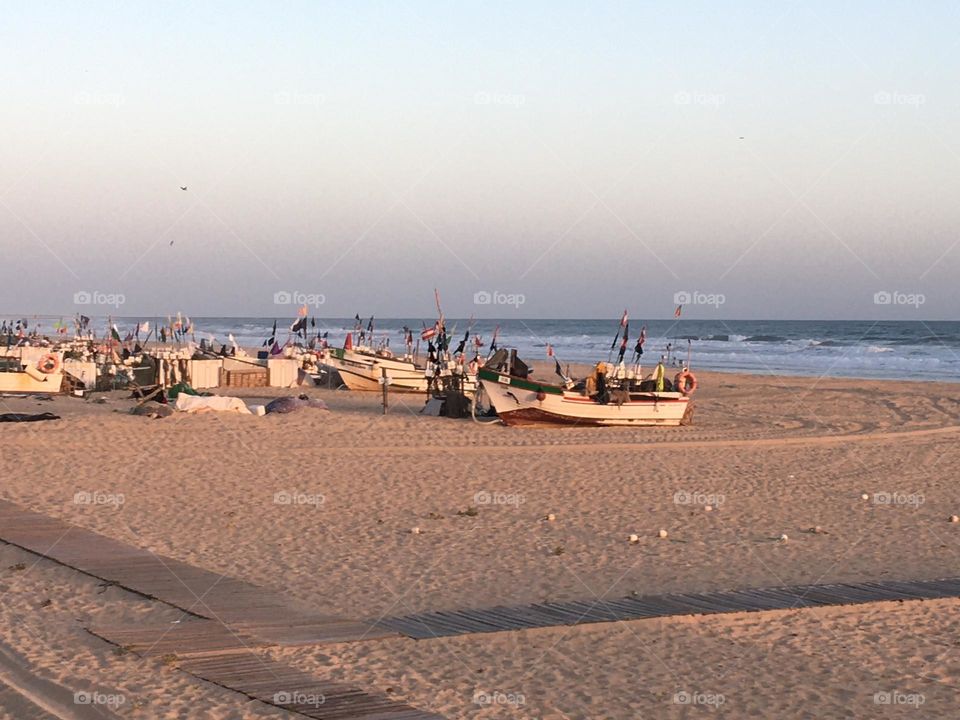 Fisherman’s boats on beach at end of afternoon 