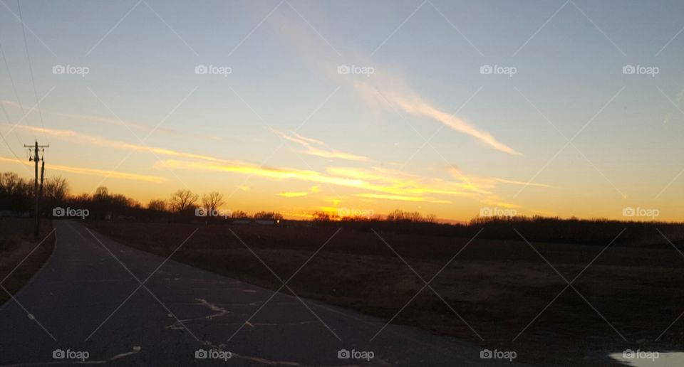 sunset on the rural road home