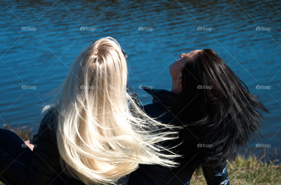 Black and blond long hair on water background