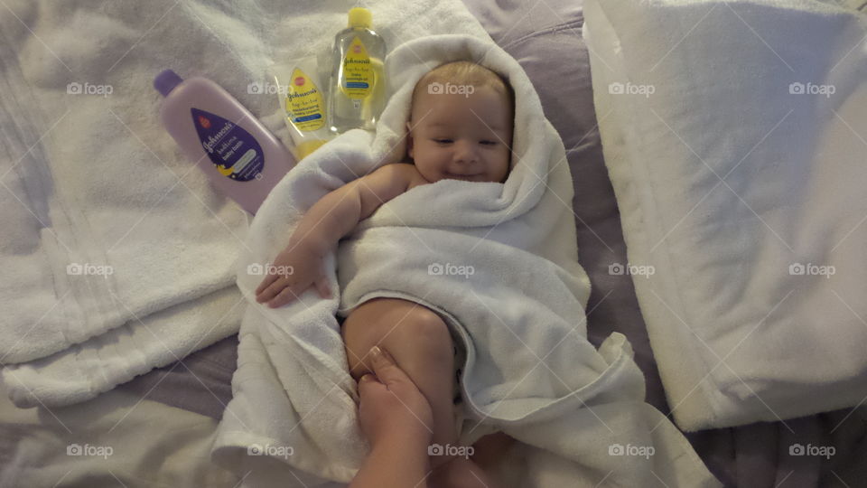 Baby boy 3 months old, being pampered by his mother with Johnson's products after his daily johnson's bath time with product placement and model release.