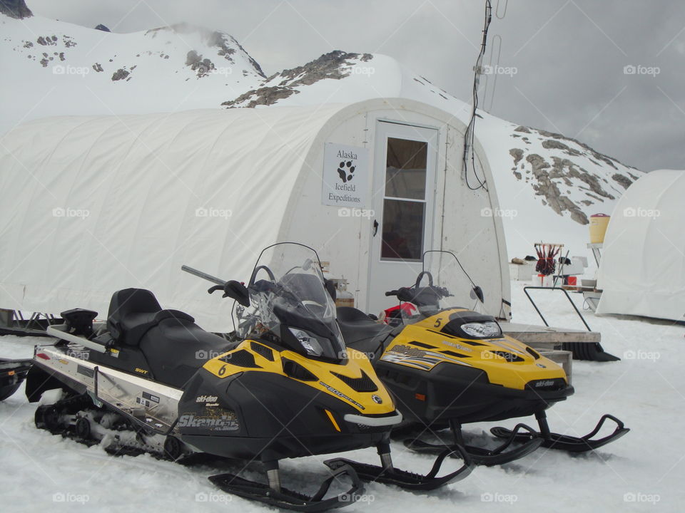 Snowmobiles and a tent