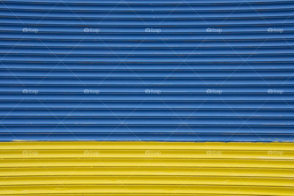 A closeup of a commercial garage door for loading incoming and outgoing goods in Brooklyn, New York City.