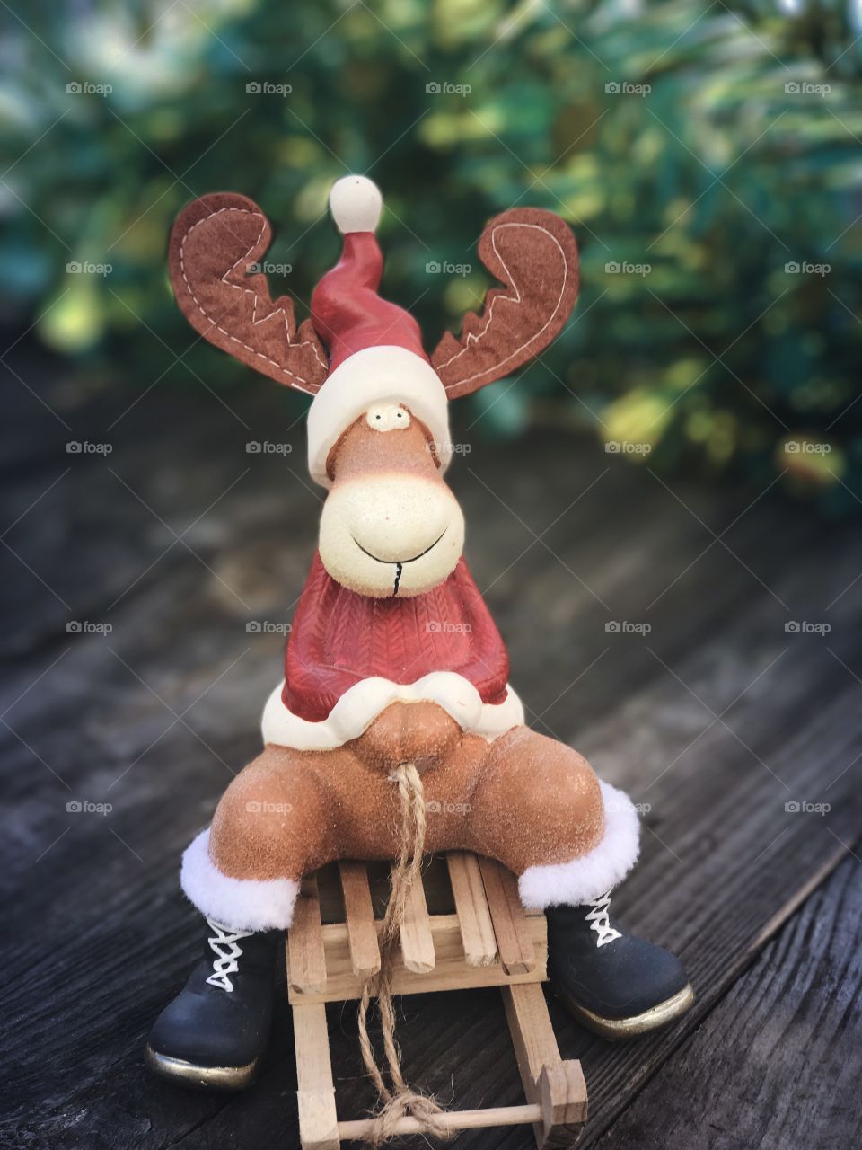 Christmas reindeer on a wooden sled on a blurred background, Christmas background