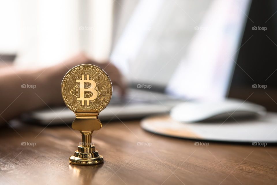 bitcoin on brown table