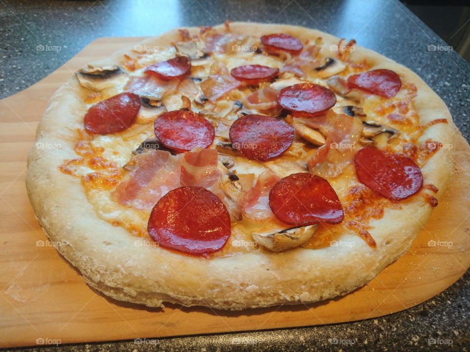 home baked Italian style pepperoni pizza piping hot just out of the oven