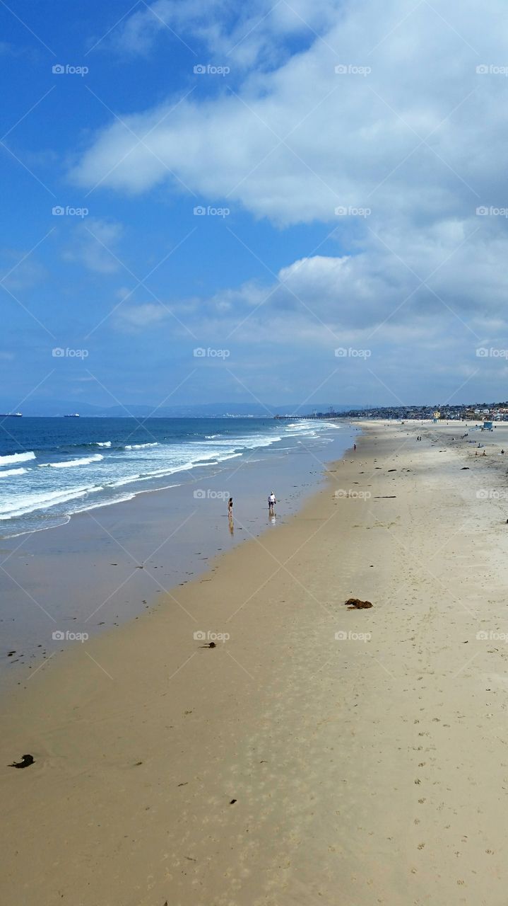 Beachcombers. Lone beachcombers walking the shore!