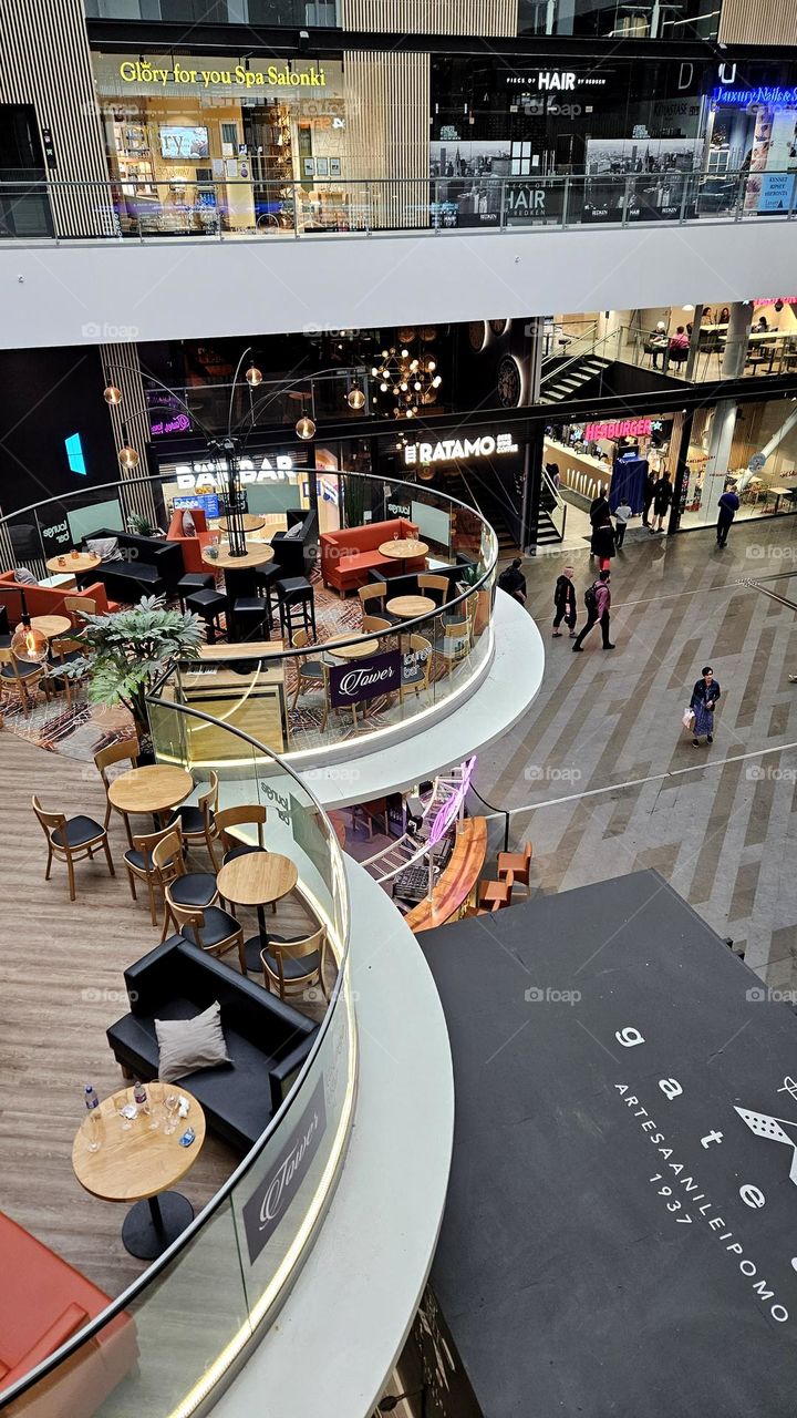 There is a cafe in the middle of the shopping center on two floors