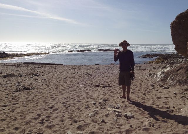 Man waving on the beach