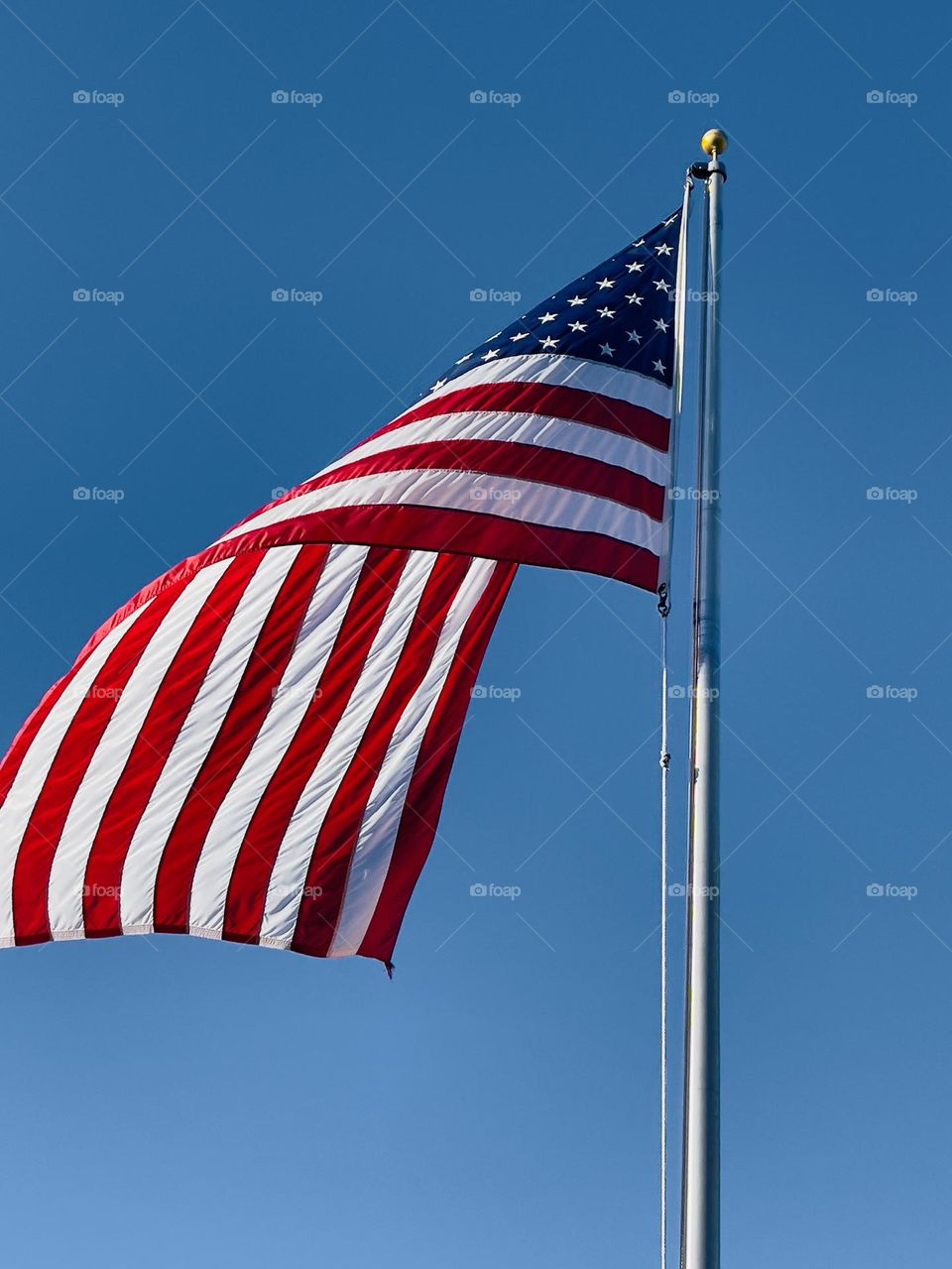 American flag on the blue sky background 