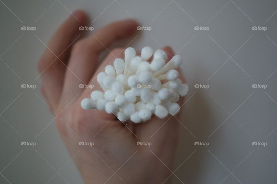 A hand holding swabs