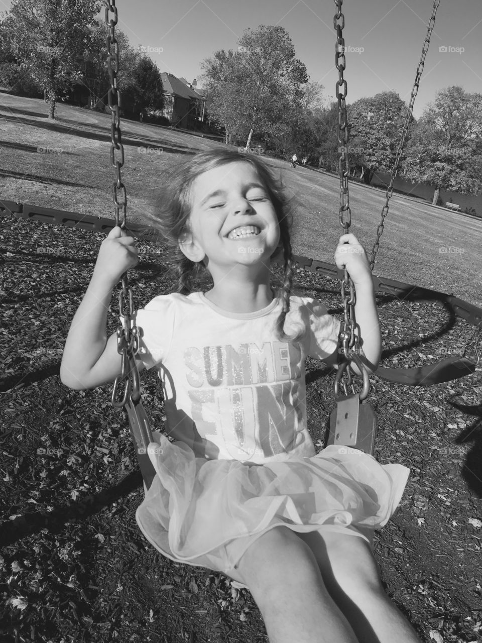 Happy child swinging in a tutu