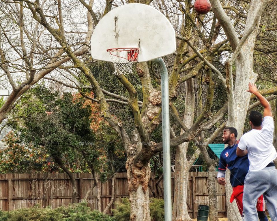 Two Friends Shooting Hoops

