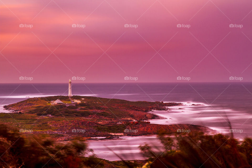 sunrise over Cape Leeuwin lighthouse on a rocky outcrop at Augusta in South West Western Australia
