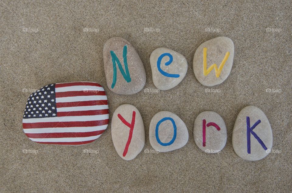 New York, on carved stones . New York with United States of America's flag, stone carved letters