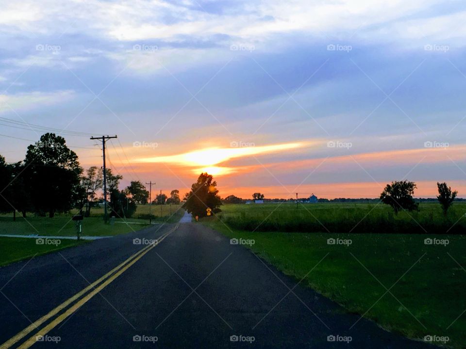 Country blacktop road at sunset
