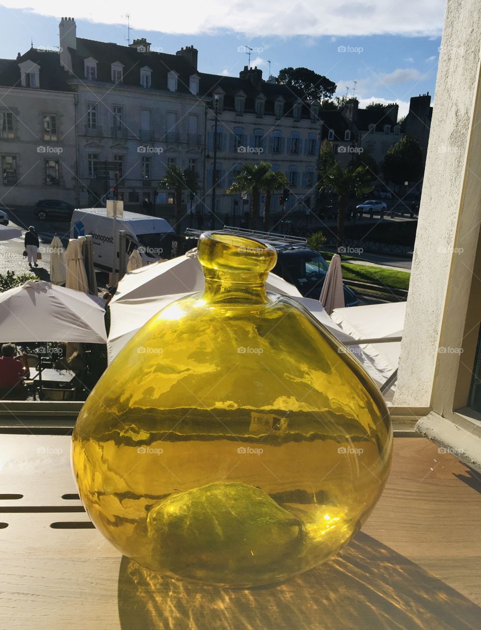 Yellow vase by the window