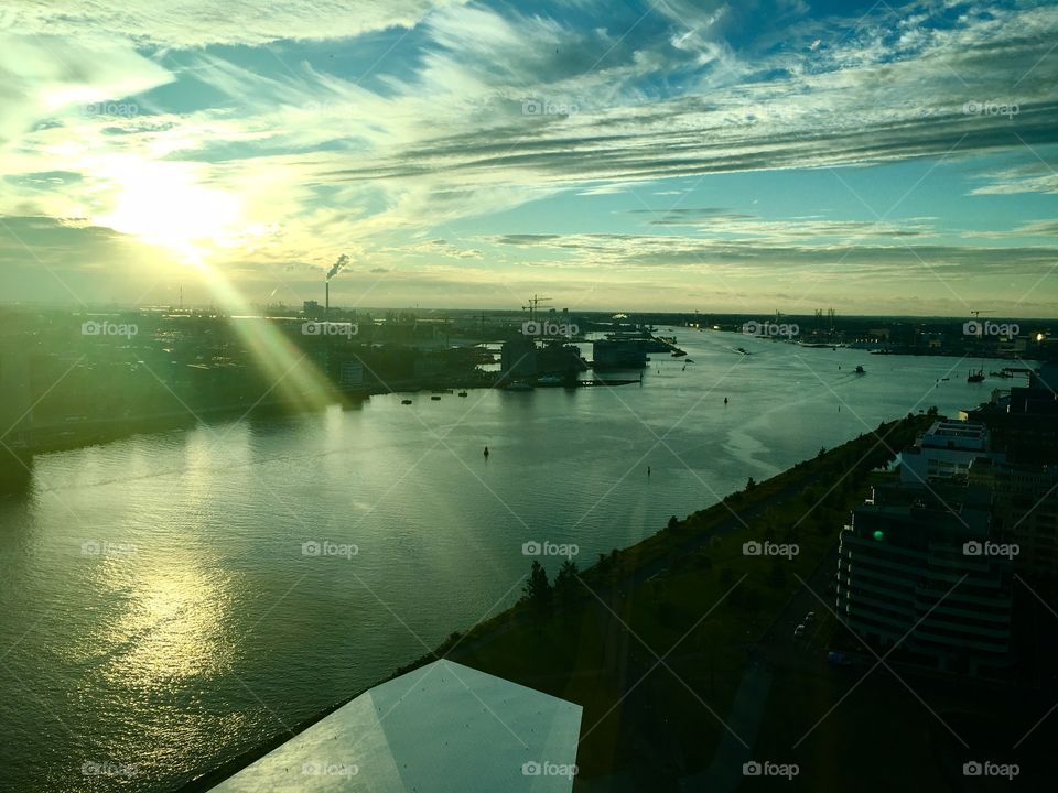 Beautiful sunset in Amsterdam viewed from high. Sun rays going over the water leaving a romantic feeling 