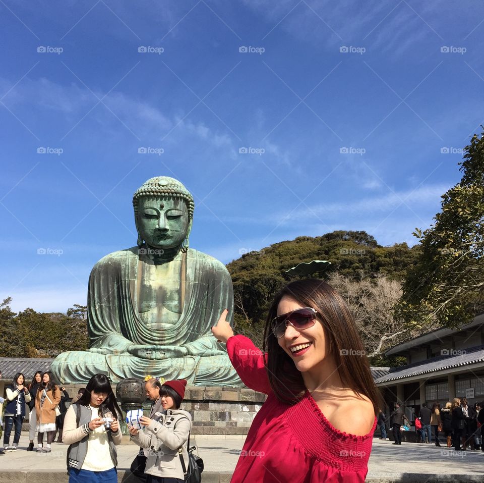 Woman standing in front of Kamakura, Japan