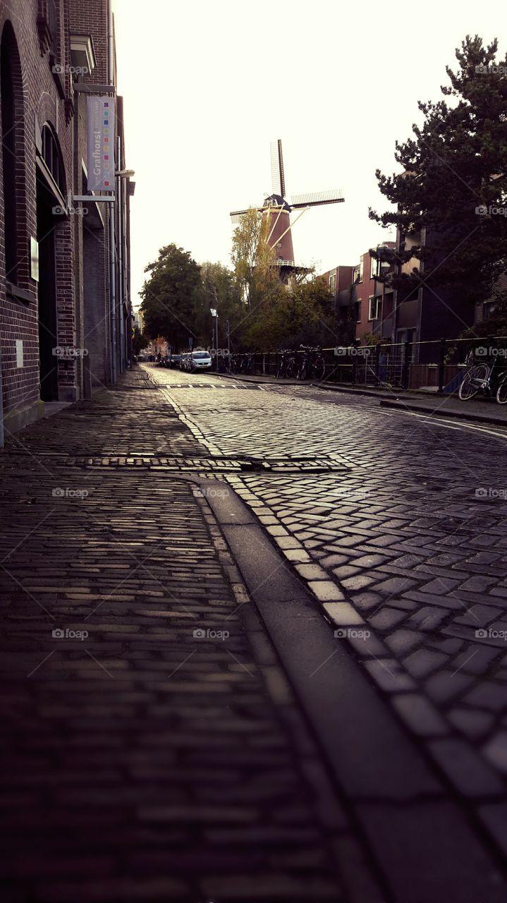 Ancient pavement and wind mill in Utrecht, Netherlands