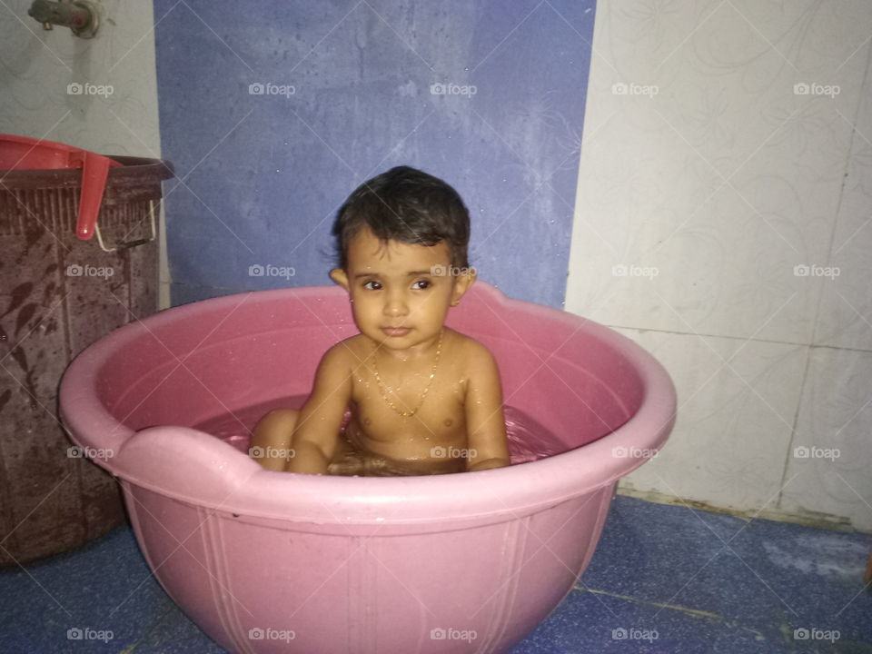 Small kid Taking a bath on tub