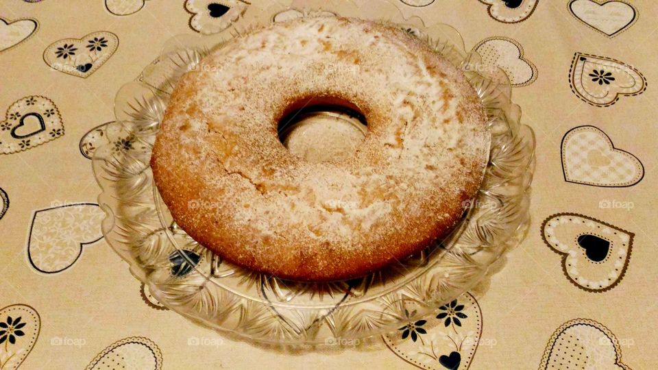 homemade  doughnut-shaped panettone on a grey heart-patterned tablecloth