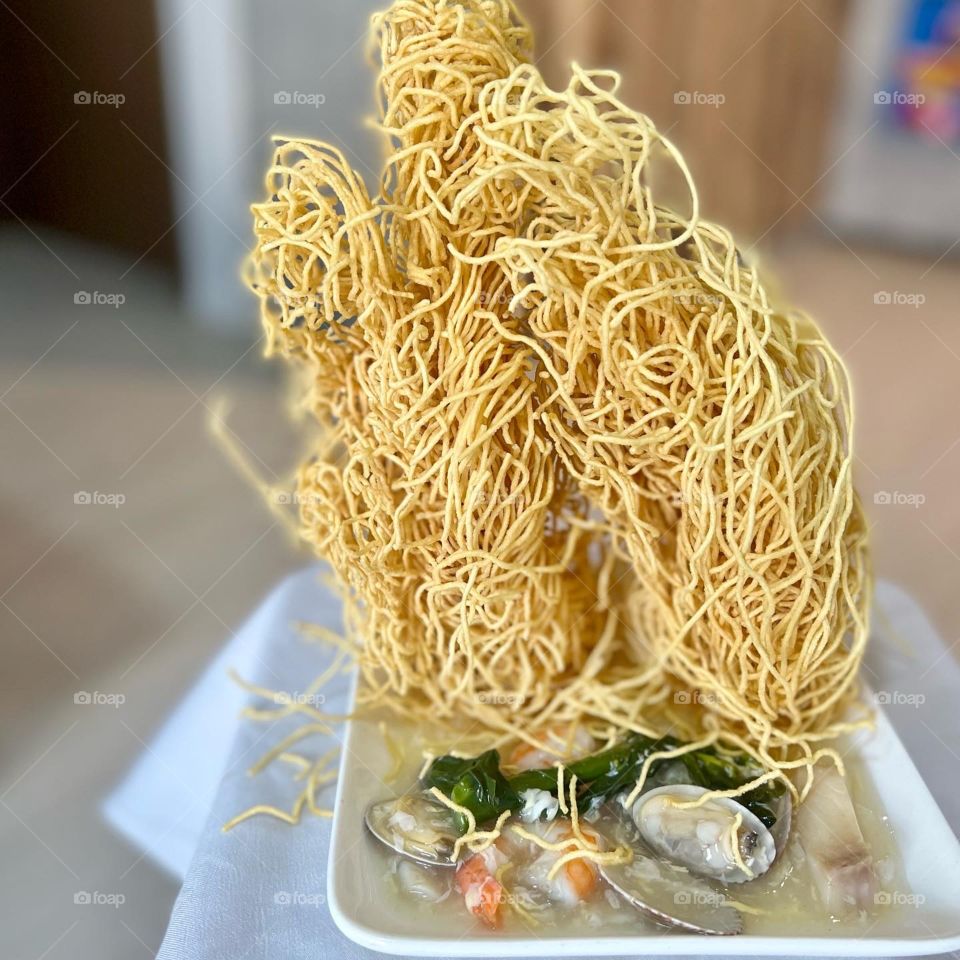 Asian food includes lala clam soup, curry fish head, bitter gourd pork and crispy twin tower noodles 