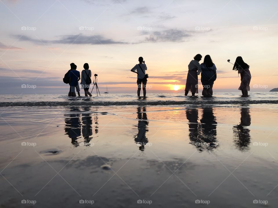 Undentified of tourist shot for sunset moment in the Tanjung Aru beach.