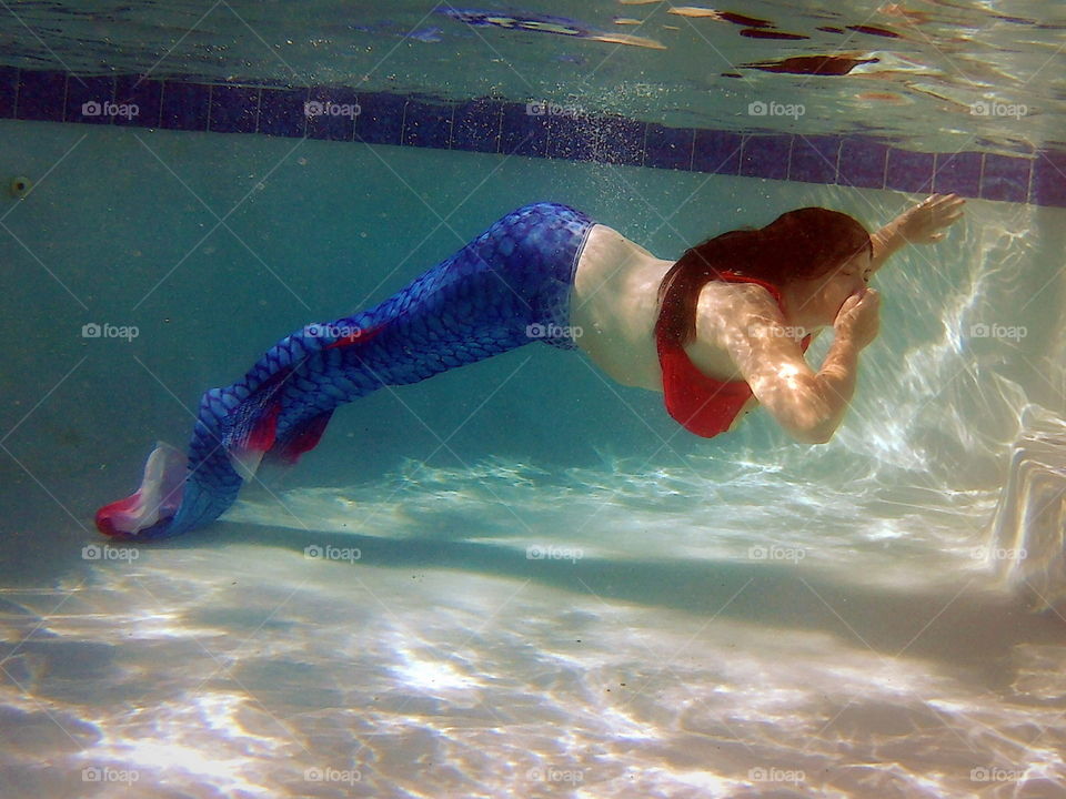 Swimming in a pool with a mermaid tail 