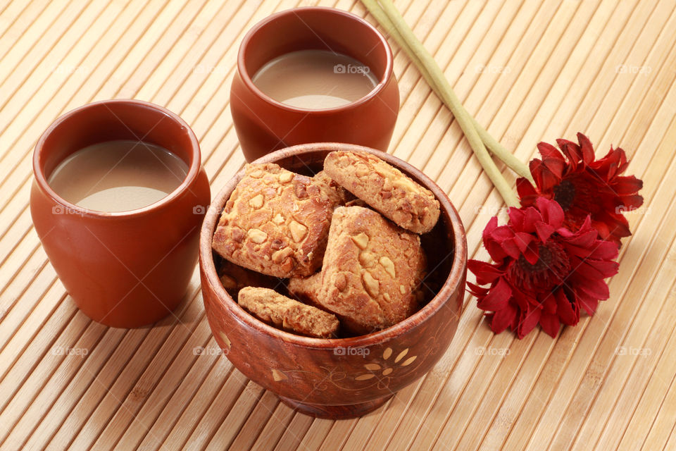 Indian traditional handmade pottery glass and tea with handmade cookies