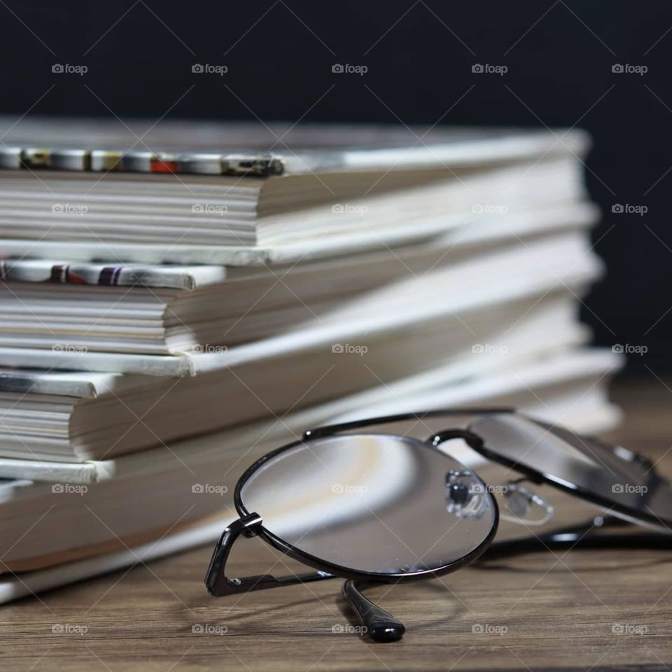 Books with a pair of glasses