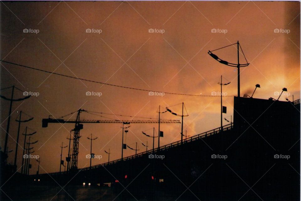 roads and buildings, orange sunset after a heavy rain on an analog camera